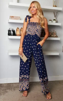 Mela London Daisy Border Shirred Tie Jumpsuit In Navy